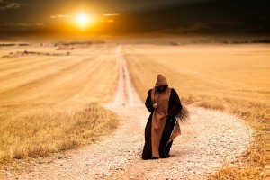 monk, hooded robe, dirt road, walking